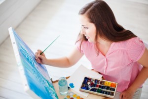 Artist paints picture on canvas